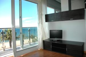 A television and/or entertainment centre at Apartamentos las Palmas VII Family only