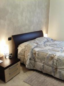 a bedroom with a bed and a nightstand with a bed sidx sidx at Staurenghi34apartmenT in Varese