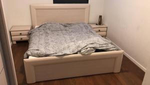 a bed in a small room with a bed frame at 29 Efraim Street Apartment in Modi'in