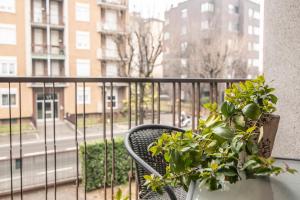 a balcony with a chair and a potted plant at Residenza Miola in Saronno