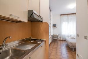 a kitchen with a sink and a counter top at Residenza Miola in Saronno +61 photos