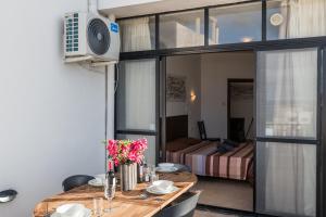 a dining room with a table and a bedroom at Seashells 2 bedroom Apartment with sunny terrace with stunning sea views - by Getawaysmalta in St Paul's Bay