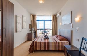 a bedroom with a bed with a teddy bear on it at Seashells 2 bedroom Apartment with sunny terrace with stunning sea views - by Getawaysmalta in St Paul's Bay