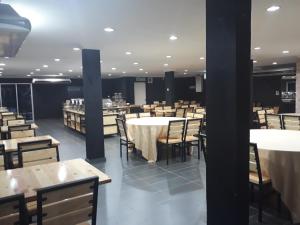 a dining room with tables and chairs and tables and tablesearcher at Hotel Seri Malaysia Temerloh in Temerloh