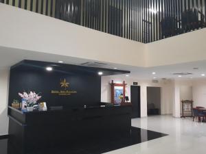 a lobby with a black and gold sign on a wall at Hotel Seri Malaysia Temerloh in Temerloh