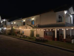 a building with lights on the side of it at night at Phaythavone Hotel in Pakse