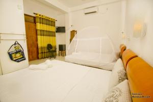 Vuode tai vuoteita majoituspaikassa Sirisara Holiday Resort
