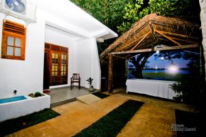 a room with a bed and a view of the ocean at Sirisara Holiday Resort in Anuradhapura