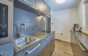 a kitchen with a sink and a microwave at D-Town Lodge in Saalbach-Hinterglemm +50 photos