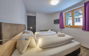 two beds in a room with purple curtains at D-Town Lodge in Saalbach Hinterglemm