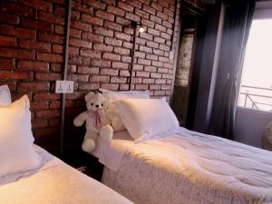 A bed or beds in a room at Cafe Beyond and Guest House