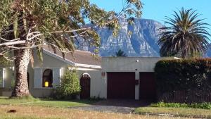 a house with a mountain in the background at 11 Lucius Way in Cape Town