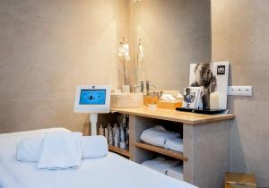 a bedroom with a bed and a desk with a computer at Le Grand Hôtel Le Touquet-Paris-Plage in Le Touquet-Paris-Plage