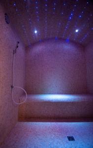 a purple room with a shower with lights on it at Le Grand Hôtel Le Touquet-Paris-Plage in Le Touquet-Paris-Plage
