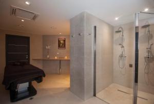 a bathroom with a shower and a sink at Le Grand Hôtel Le Touquet-Paris-Plage in Le Touquet-Paris-Plage