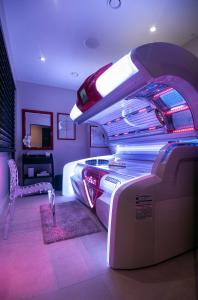 a hotel room with a bed and a room with a car at Le Grand Hôtel Le Touquet-Paris-Plage in Le Touquet-Paris-Plage