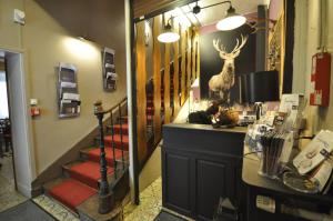 a room with a staircase with a deer head on the wall at Auberge de la Paix in Briançon