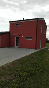 a red building with a parking lot in front of it at Apartmány Klimkovice in Klimkovice