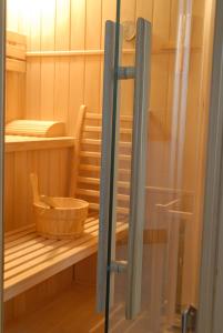 a wooden bowl on a shelf in a sauna at Hotel Restaurant L Echo du Lac in Gérardmer