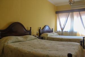 a bed with two pillows and a lamp on top of it at Telhadense in Castelo Branco