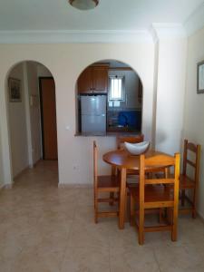 eine Küche und ein Esszimmer mit einem Tisch und Stühlen in der Unterkunft Apartamento en La Cala in Cala de Finestrat
