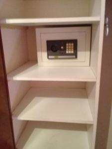 a white cabinet with a microwave in a room at Hotel El Torreon in Mendoza