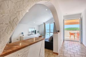 a kitchen and living room with a view of the ocean at Apartmani ATL in Rogoznica