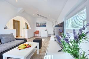 a living room with a couch and a table at Apartmani ATL in Rogoznica
