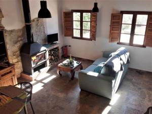 a living room with a couch and a fireplace at Cortijo Berruguilla in Lojilla