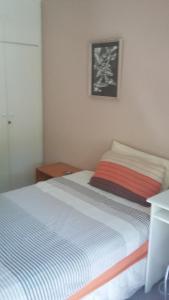 a bedroom with a bed and a picture on the wall at 11 Lucius Way in Cape Town