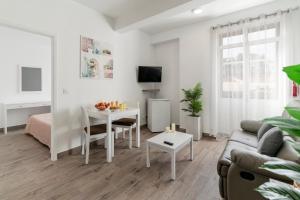 a living room with a couch and a table at Funchal City Apartments in Funchal