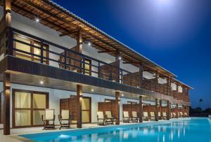 a villa with a swimming pool at night at Rox Hotel in Jericoacoara