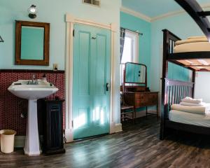 a bathroom with a sink and a bunk bed at The Hostel California in Bishop