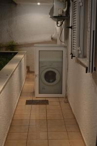 a washing machine sitting in the corner of a room at Αpartment at the entrance of the city Dimitropoulos in Aigio