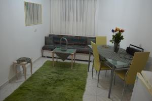 a living room with a couch and a table and chairs at Apartment in the Center of Aigio F in Aigio