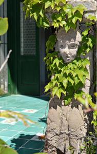 Una statua di un volto sul lato di una casa di Casa Cecilia a Ravello