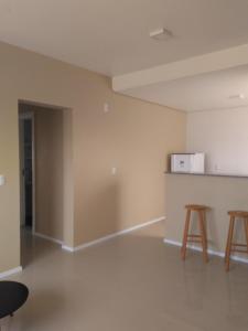 an empty room with two chairs and a counter at Residencial Beira Mar in Cassino +9 photos