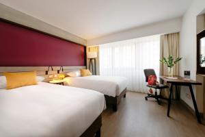 Postel nebo postele na pokoji v ubytování Mercure Ariosto Lima