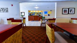 a restaurant with tables and chairs and a dining room at Days Inn by Wyndham Greensboro NC in Greensboro