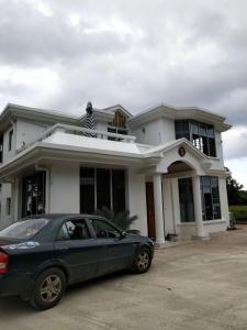 a car parked in front of a house at Suva Hideaway Villa in Suva