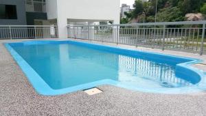 a pool with blue water in a building at HD GUEST HOUSE KUANTAN in Kuantan