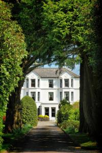 a large white house with a pathway leading to it at Seaview House Hotel in Bantry