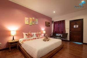 a bedroom with a bed with a cat sitting on it at Aukotan Place in Koh Tao +12 photos