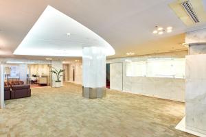 a lobby of a building with a large room at Marroad Inn Hachioji in Hachioji