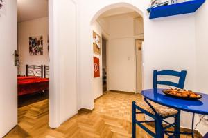 a blue table and chairs in a room at Petaluda House 3 in Athens