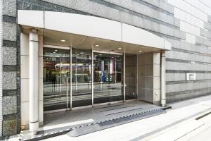 an entrance to a building with glass doors at Marroad Inn Hachioji in Hachioji