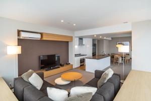 a living room with a couch and a table at The Maples Niseko in Niseko