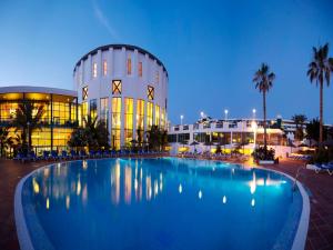 a large swimming pool in front of a building at Sandos Papagayo in Playa Blanca
