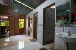 a bathroom with a sink and a mirror at Mekong Rustic Cai Be in Cai Be