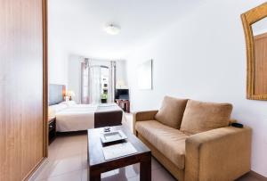 a living room with a couch and a bed at Toboso Apar - Turis in Nerja